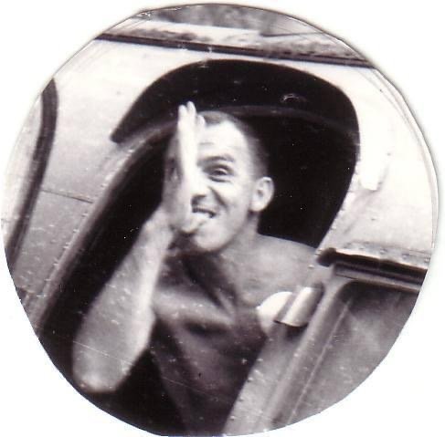 Robert A. Cary smiling from an aircraft cockpit