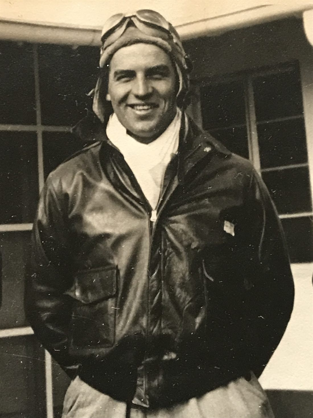 Robert A. Cary wearing flight gear and a leather flight jacket